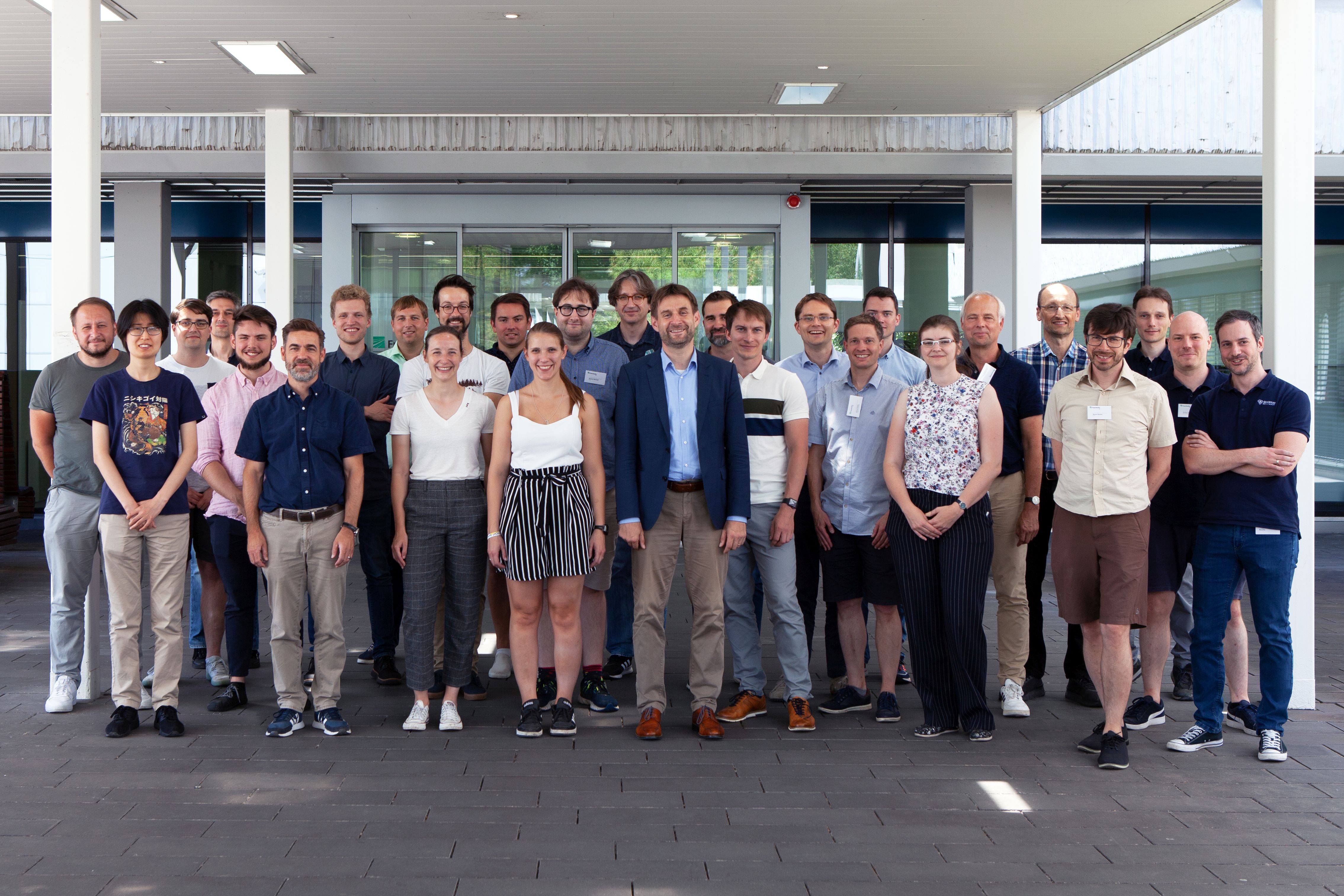 the spinning project consortium: 36 people infront of the Fraunhofer IAF main entrance