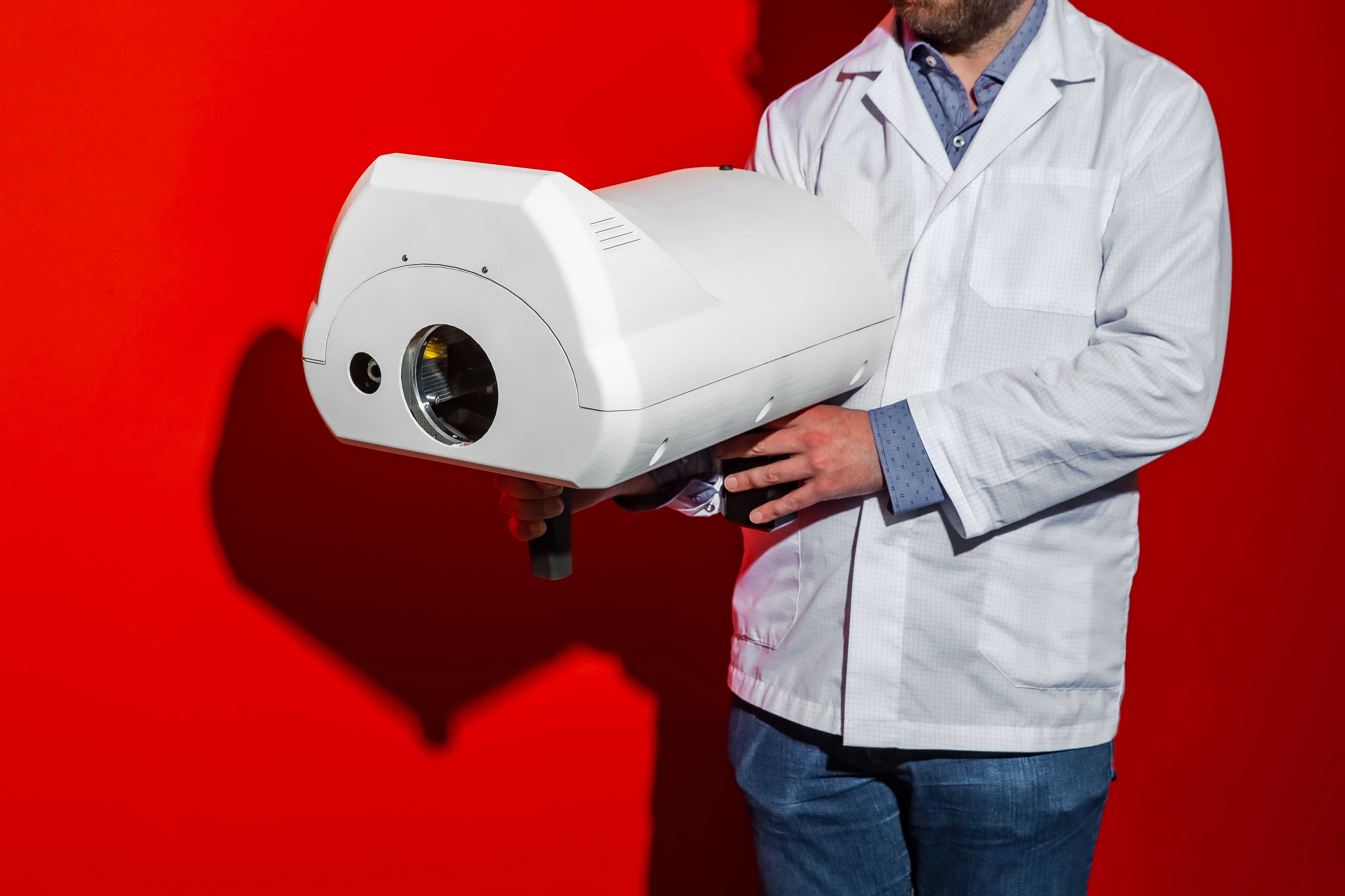 Scientist holding scanner for hazardous substances and explosives