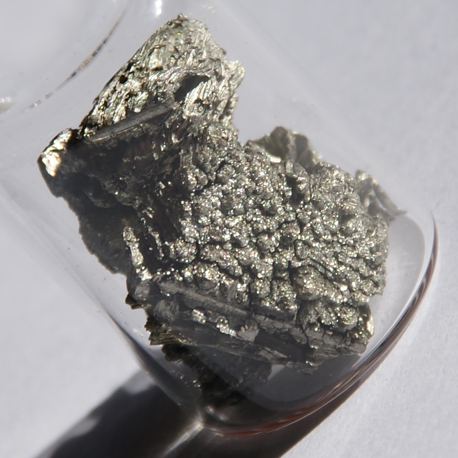 Glass container filled with a scandium crystal
